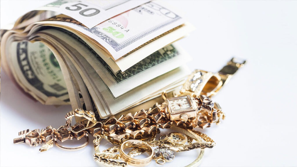 roll of dollars and gold jewelry