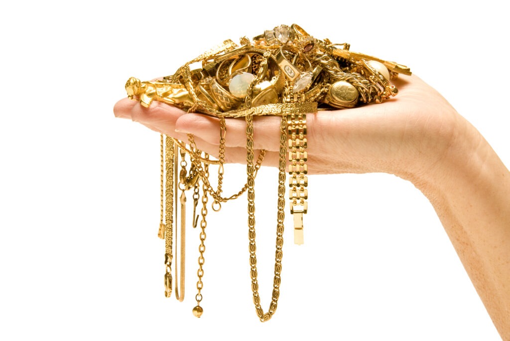 pile of gold jewelry in hand