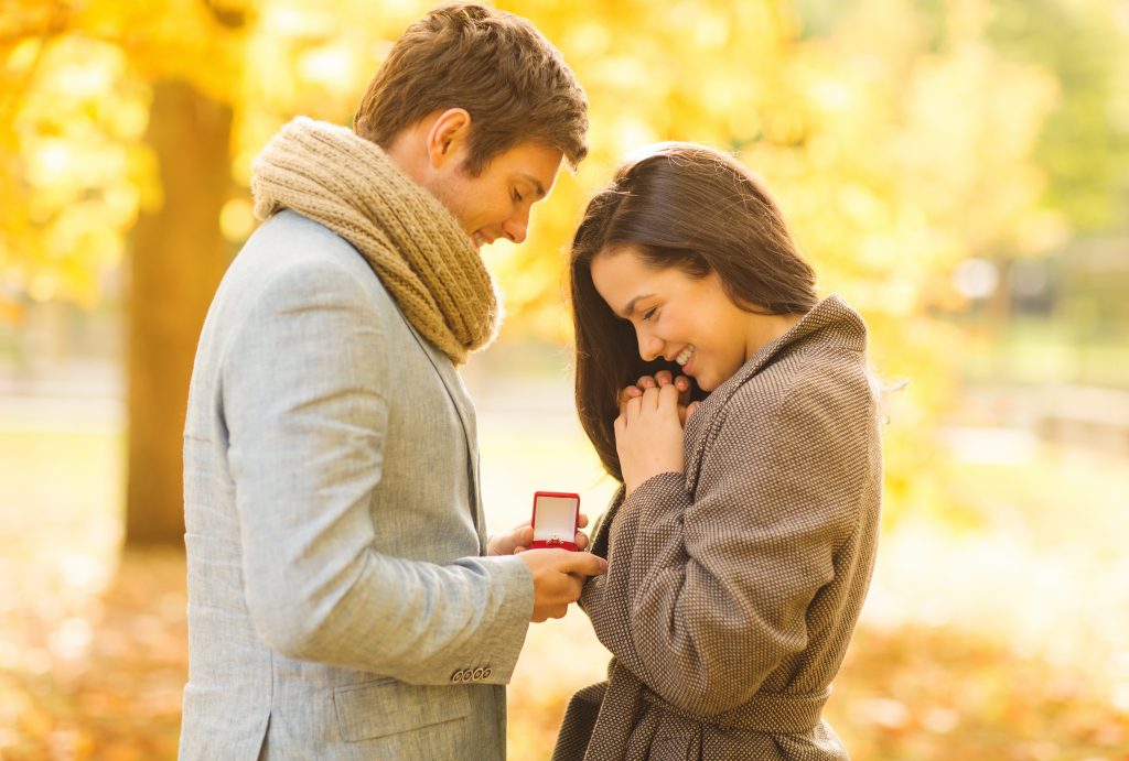 man giving woman engagement ring