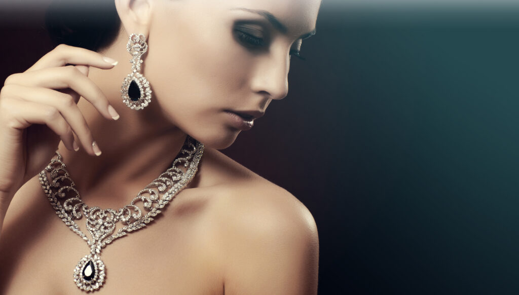 woman wearing diamond earrings and necklace