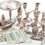 silver candle holders and hundred dollar bills