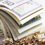 roll of dollars with jewelry