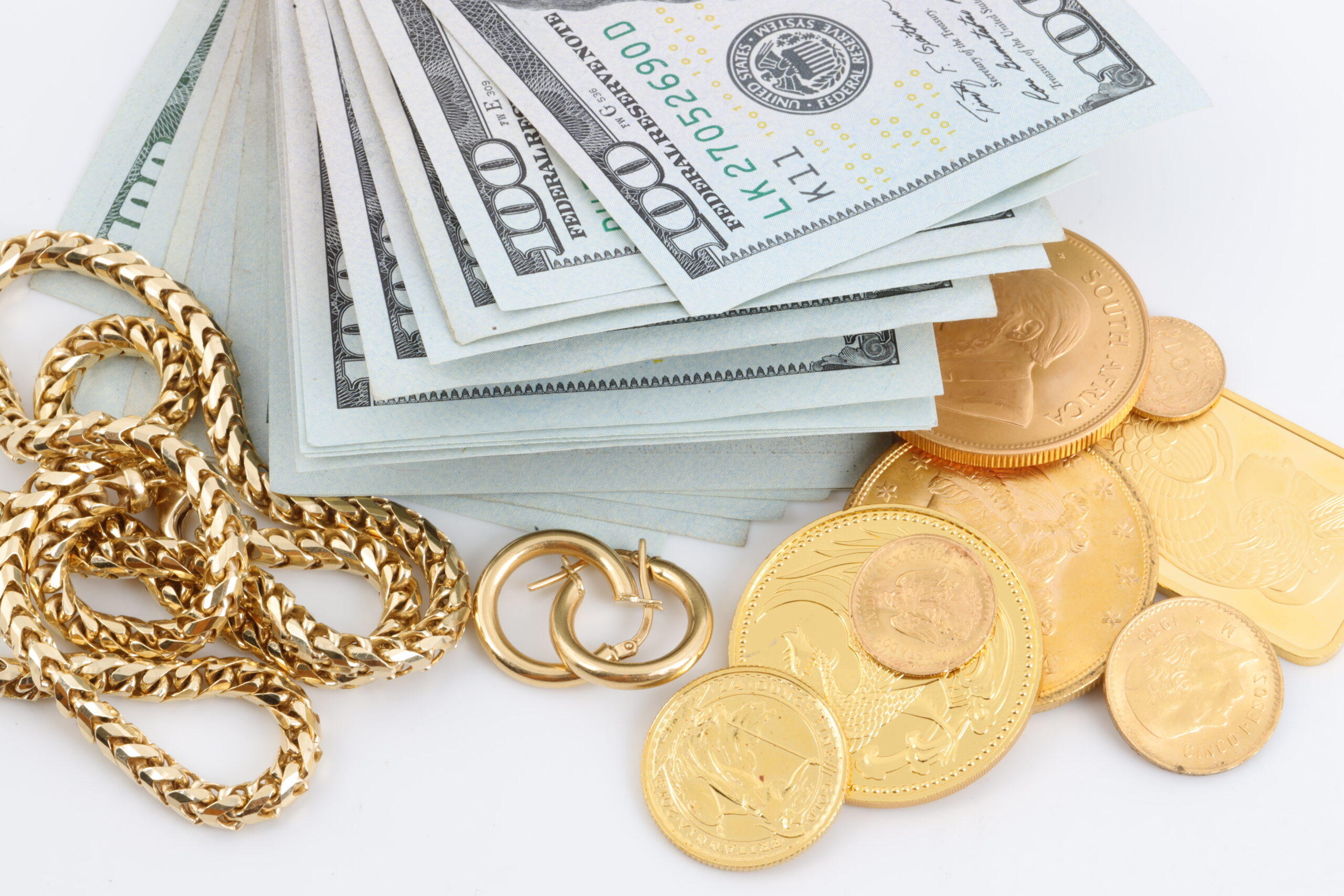 Miscellaneous gold jewelry, along with a stack of money and golden coins