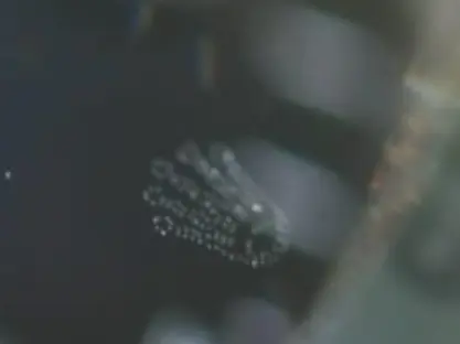 Close-up of Rolex crown logo on dial and tiny etched crystal crown on authentic watch compared to misaligned and flawed fake.